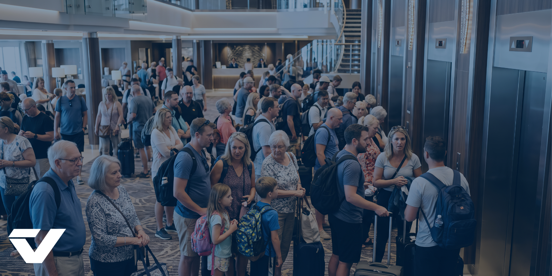 Image of crowds waiting for elevators in a hotel lobby.